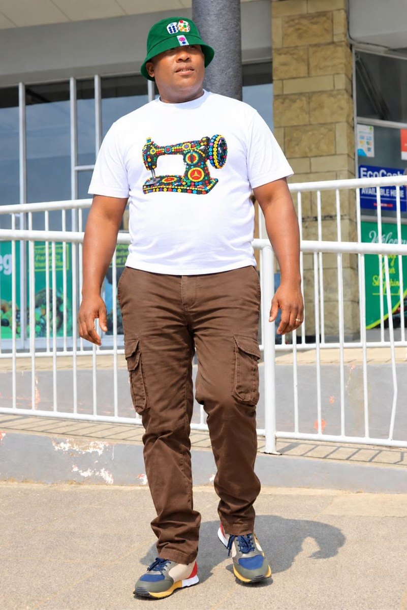 A man wearing the sewing machine t-shirt and a green cap